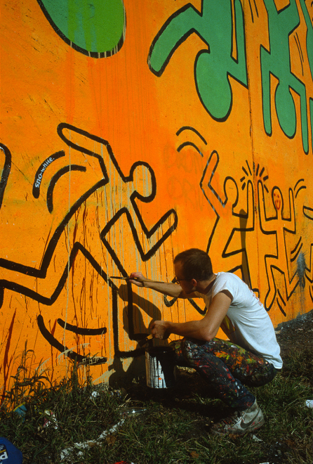 Keith Haring paints an orange mural with figures